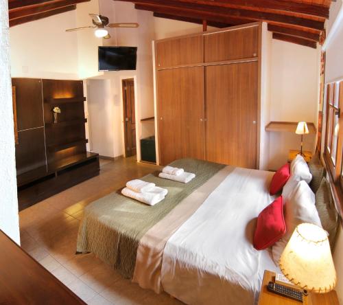 a bedroom with a large bed in a room at Posada de Campo - Hotel Boutique - Adults Only in Villa General Belgrano