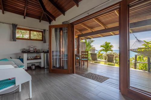 a living room with a door open to a patio at The Tranquilo Lodge, Adult Only, All meals included in Drake