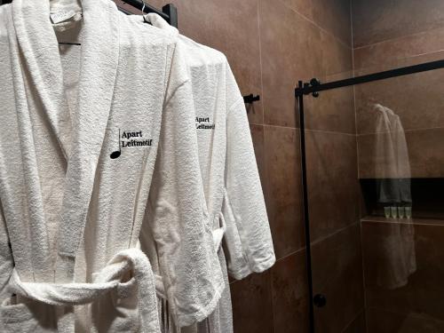 a group of white towels on a rack in a bathroom at Apart leitmotif in Tbilisi City