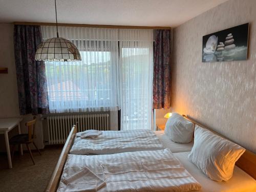 a bedroom with a bed and a large window at Doppelzimmer Nr. 1 in Freiensteinau