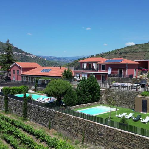 a villa with a swimming pool and a house at Quinta da Pitarrela in Peso da Régua