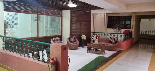 a balcony of a building with chairs on it at Majorda Coastal Homestay in Nuvem