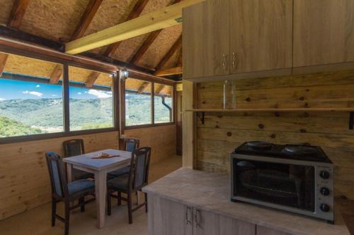 a kitchen with a small table and a stove at Kuća za odmor Andrea in Bajina Bašta