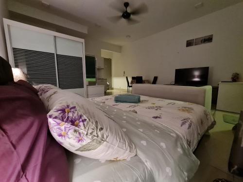 a bedroom with a bed with pillows on it at The Urban Getaway - 118 Tower View in Cyberjaya