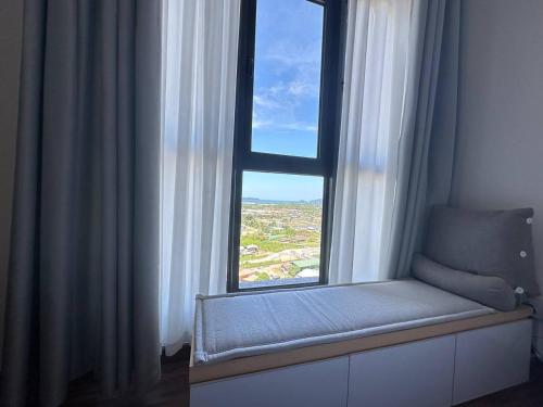 a window with a bench in a room with a view at K Avenue Seaview Nearby Kota Kinabalu Airport in Kota Kinabalu