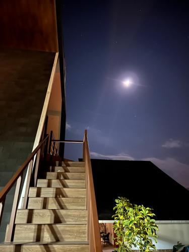 a view of a stairway at night with the moon at Habitación Alpes doble independiente in Oxapampa