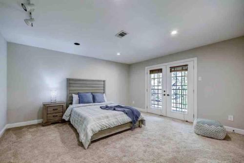 a bedroom with a large bed and a window at Golf course view vacation home in The Woodlands