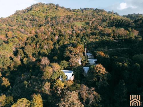 an aerial view of a house in the middle of a forest at Arabica Lodge (อาราบิก้า ลอดจ์) in Ban Huai Khai