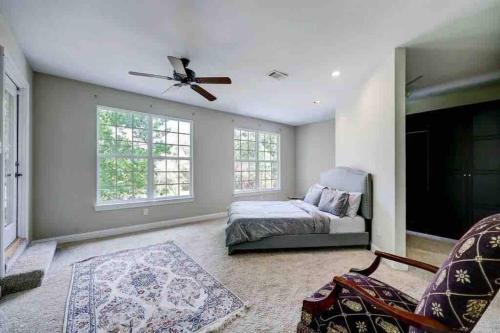 a bedroom with a bed and a ceiling fan at Golf course view vacation home in The Woodlands