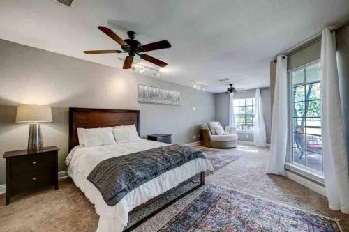 a bedroom with a bed and a ceiling fan at Timber Top golf course view in The Woodlands