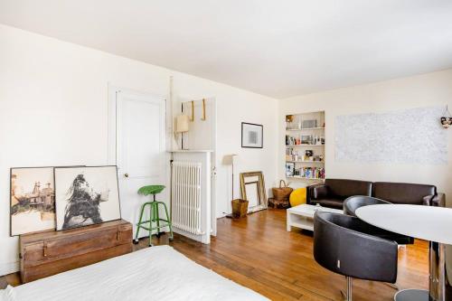 a living room with a couch and a table at Bel appartement à Ile saint Louis, Paris centre in Paris