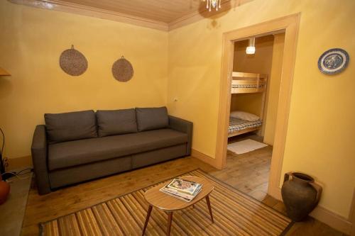 a living room with a couch and a table at Casa do Outeiro in Meda