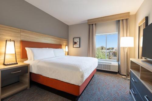 a hotel room with a bed and a window at Candlewood Suites Bessemer - Birmingham SW by IHG in Bessemer