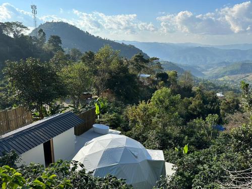 a white tent sitting on top of a house at Arabica Lodge (อาราบิก้า ลอดจ์) in Ban Huai Khai