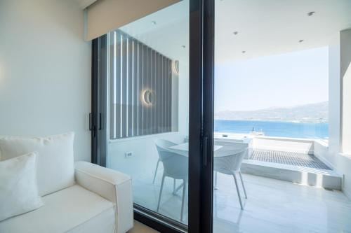 a living room with a couch and a view of the ocean at GM exclusive Luxury Suites & SPA in Sitia