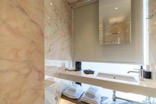 a bathroom with a sink and a mirror at GM exclusive Luxury Suites & SPA in Sitia