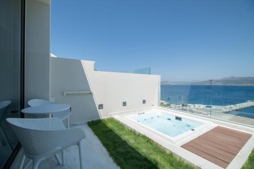 a house with a swimming pool with a table and chairs at GM exclusive Luxury Suites & SPA in Sitia