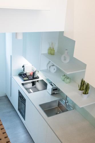 a small kitchen with white cabinets and a sink at GM exclusive Luxury Suites & SPA in Sitia
