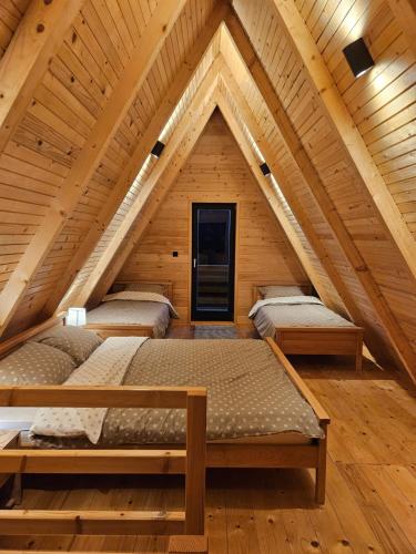 a room with four beds in a attic at A Jahorina in Jahorina