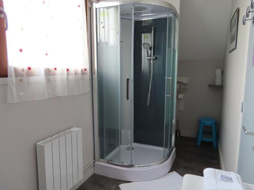 a shower in a bathroom with a glass shower stall at La CHAMBRE in Évran