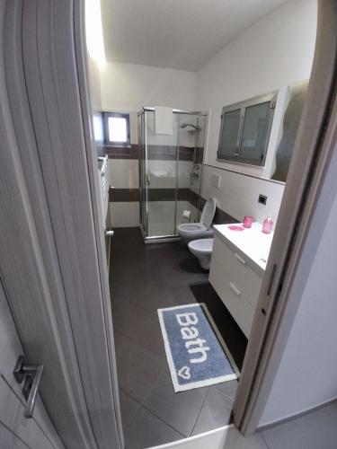a bathroom with a shower and a toilet and a sink at Piazzimmacolata53 in Molfetta