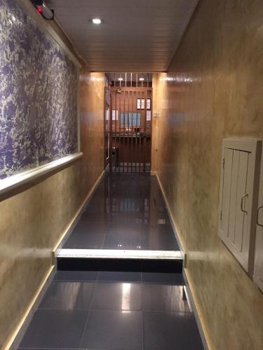 a hallway with a long corridor with a door at Belo Motel in Belo Horizonte