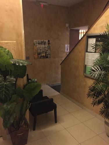 a waiting room with plants and a stair case at Belo Motel in Belo Horizonte