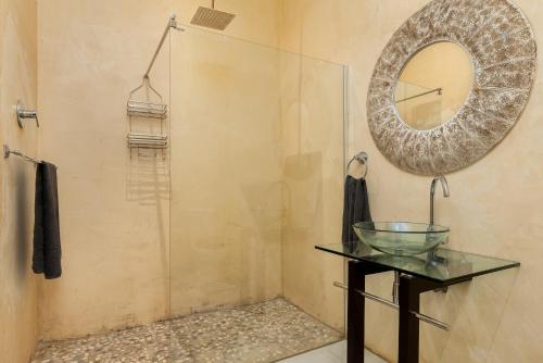 a bathroom with a mirror and a glass table at Ukholo Lodge in Citrusdal