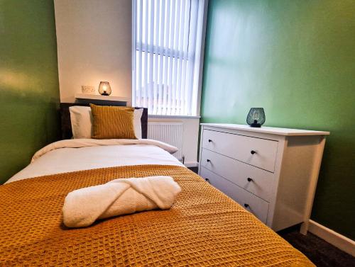 a bedroom with a bed with a towel on it at Modern 2 bedroom flat County Rd in Liverpool