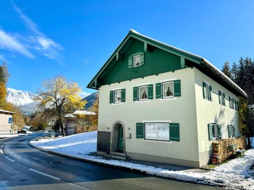 a house with a green roof on a street at Ferienwohnung Saunahaus in Annaberg im Lammertal