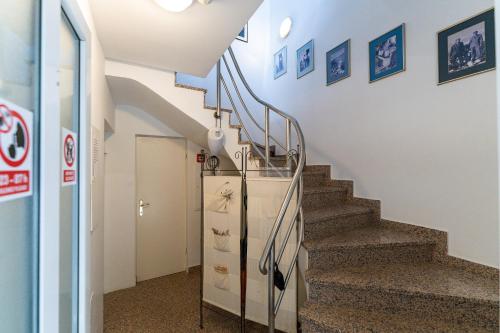 a staircase in a building with a stair case at Apartments Villa Tereza in Novalja