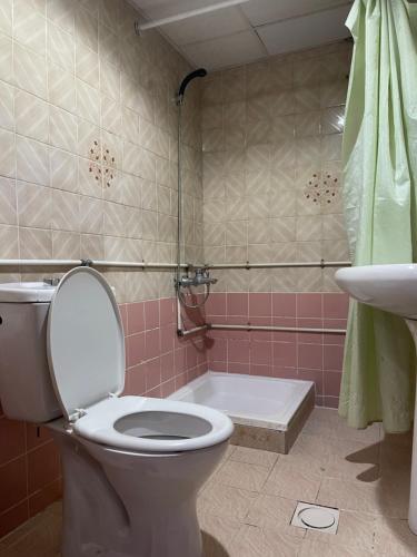 a bathroom with a toilet and a shower and a sink at Saeed Hotel in Dubai