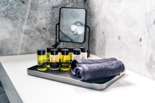 a tray with bottles of essential oils and a towel at GM exclusive Luxury Suites & SPA in Sitia