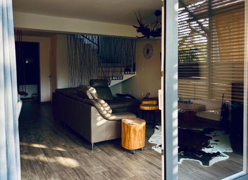 a living room with a couch and a table at House DIKA- sauna & jacuzzi in Otočac