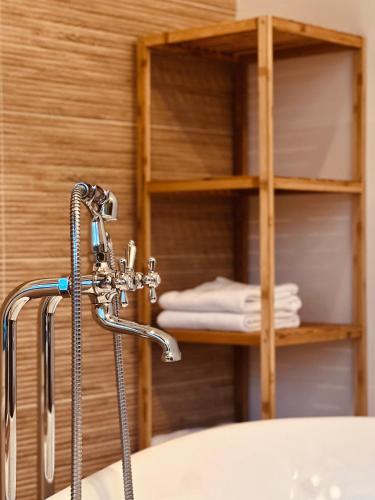a bathroom with a shower head and a sink at House DIKA- sauna & jacuzzi in Otočac