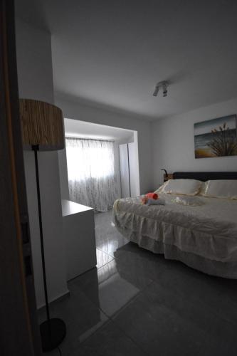 a bedroom with a bed and a lamp in it at Apartman Meri in Smokvica