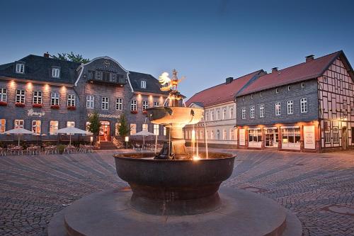a fountain in the middle of a town square with buildings at FeWo Goslar Harz in Goslar