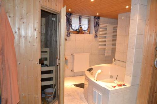 a large bathroom with a tub and a sink at Gegg's Ferienwohnung II in Dollnstein
