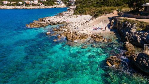 an aerial view of a beach with people in the water at APARTMANI LUX SEA in Utjeha