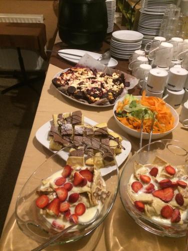a table with three plates of food on it at Penzion Real in Bedřichov
