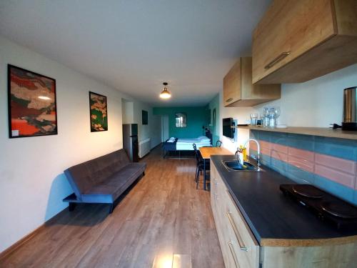 a kitchen and living room with a couch and a table at Hestia - Hotel, Wine and View in Tʼelavi