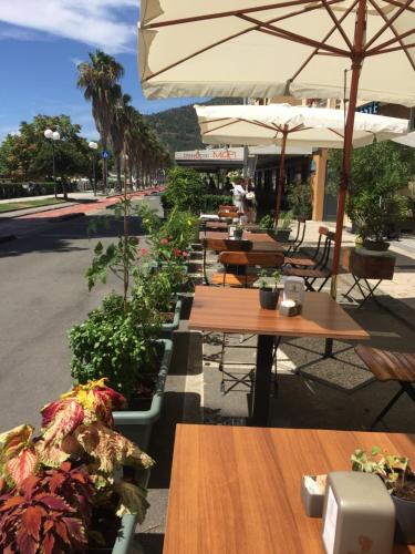 a row of tables and umbrellas on a street at Seven boutique hotel in Sestri Levante