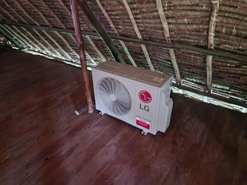 a white fan sitting on a wooden floor at Karibuni, Villa 107, Beachfront Stay with Restaurant, Pool & Bar in Malindi