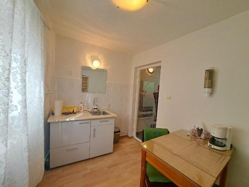 a kitchen with a sink and a table with a tableablish at Casa Mari in Sibiu