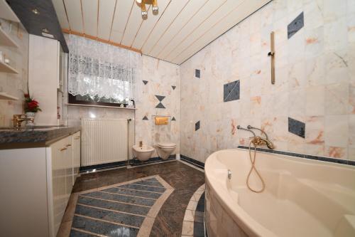 a bathroom with a tub and a sink and a toilet at Stevin ranc in Bosanska Dubica