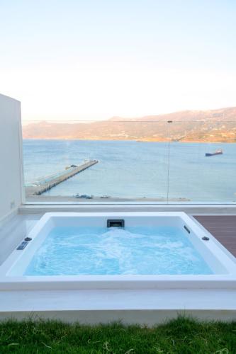 a hot tub with a view of the water at GM exclusive Luxury Suites & SPA in Sitia