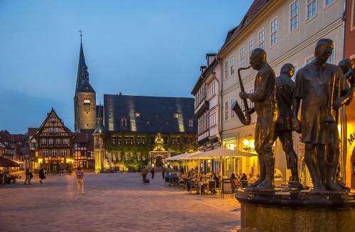 a statue of two men on a street in a city at FeWo im Harz in Bad Harzburg