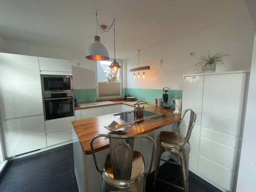 a kitchen with a wooden table and two chairs at Urban house for families and Berlin tourists in Teltow