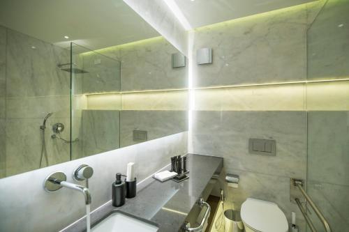 a bathroom with a shower and a sink and a toilet at GM exclusive Luxury Suites & SPA in Sitia