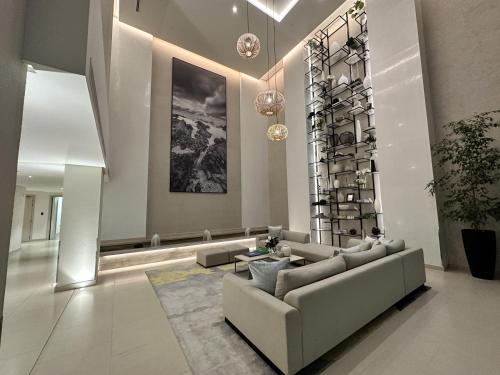 a living room with a couch and a wine rack at Marassi Beach Residence in Rayyā